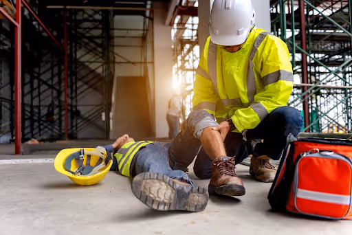 Construction worker attending to injured colleague