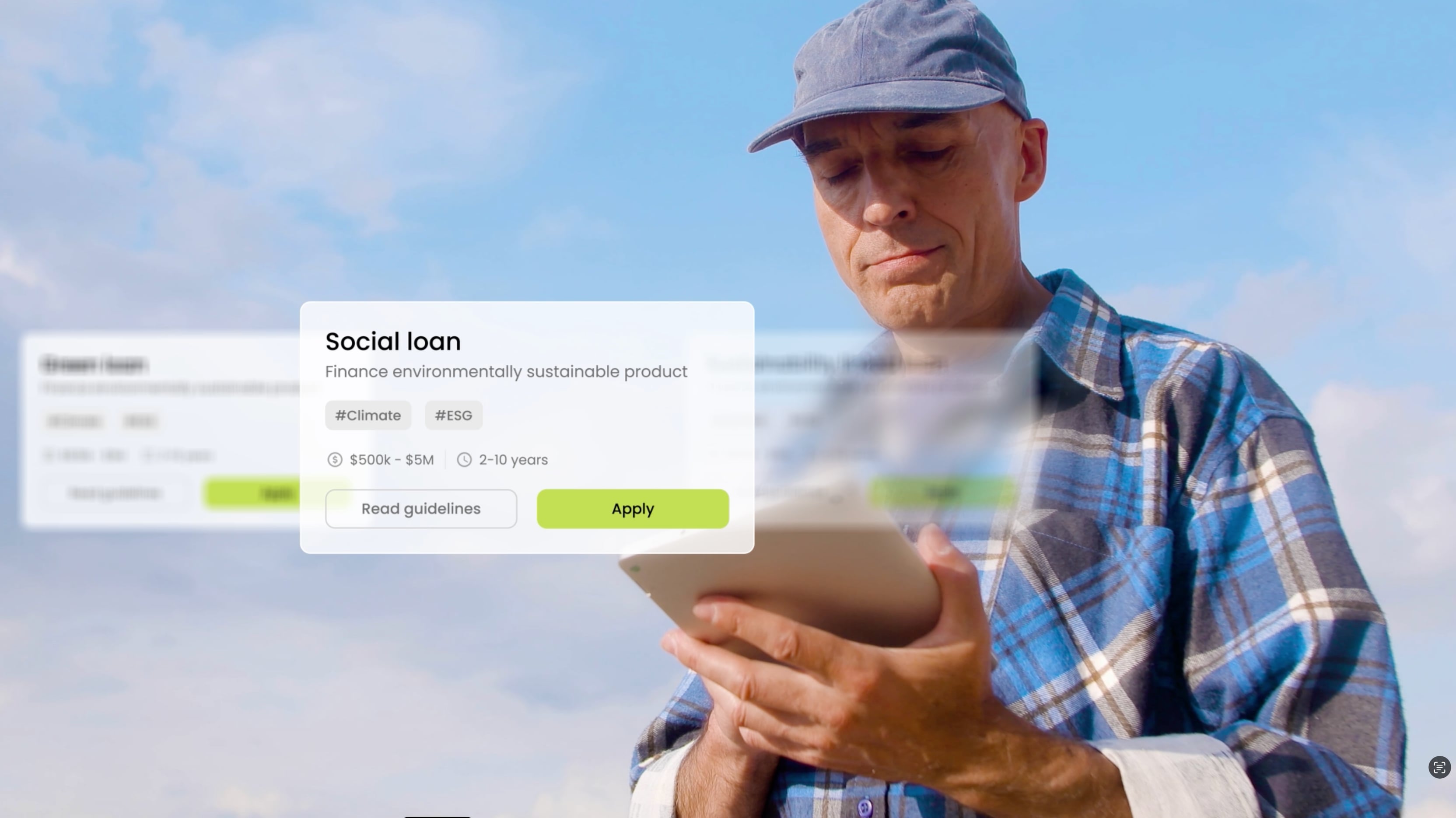 Man in a blue plaid shirt and cap looking at a tablet with a digital interface showing social loan details for financing an environmentally sustainable product.