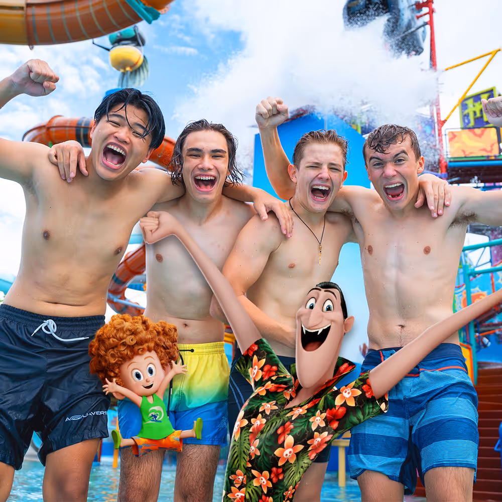 Group of excited young men posing at a colorful water park, joined by animated characters from Hotel Transylvania, including Dracula and Dennis, with water slides and splash effects in the background.

