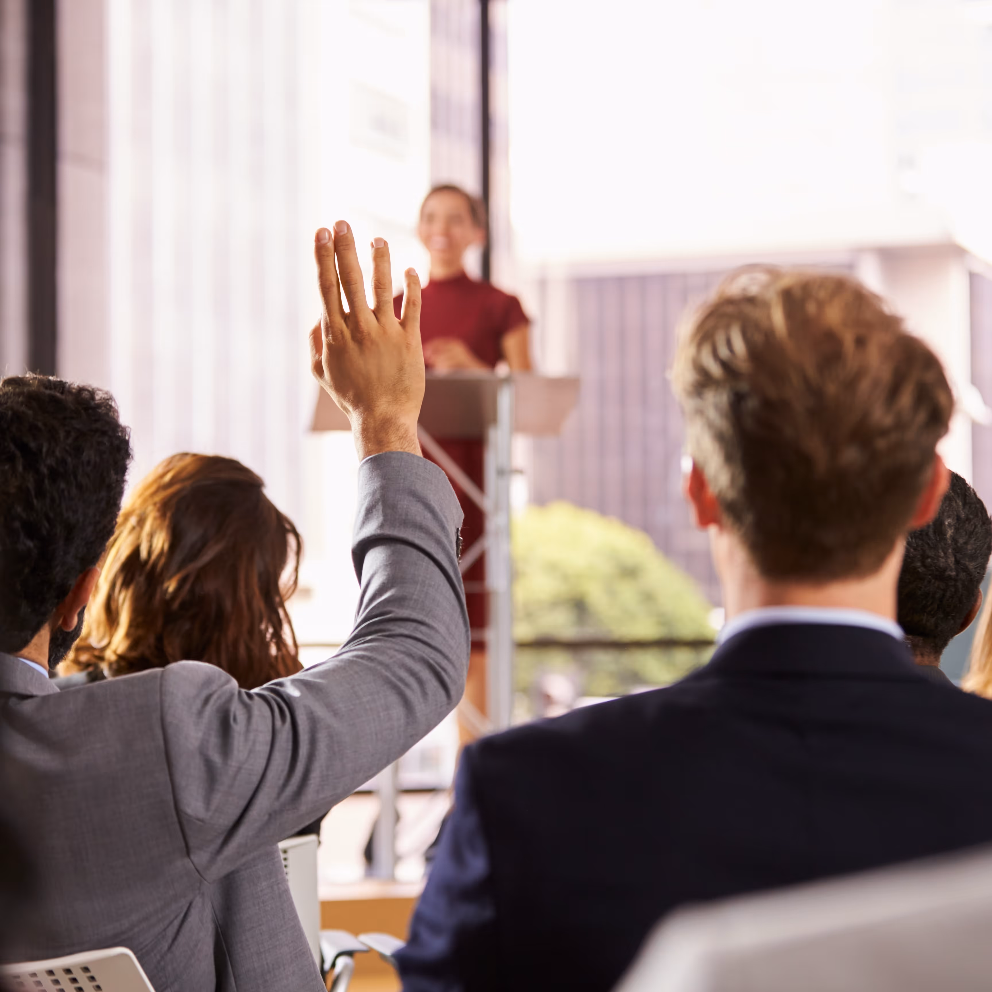 Presenter at a seminar takes a question from audience
