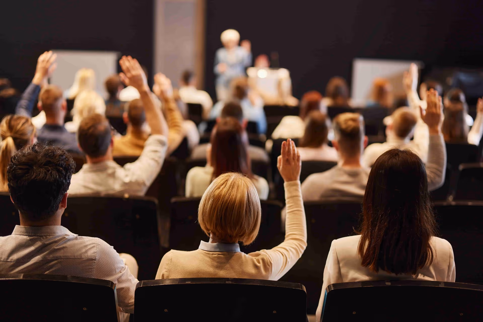 Presenter at seminar takes questions from audience