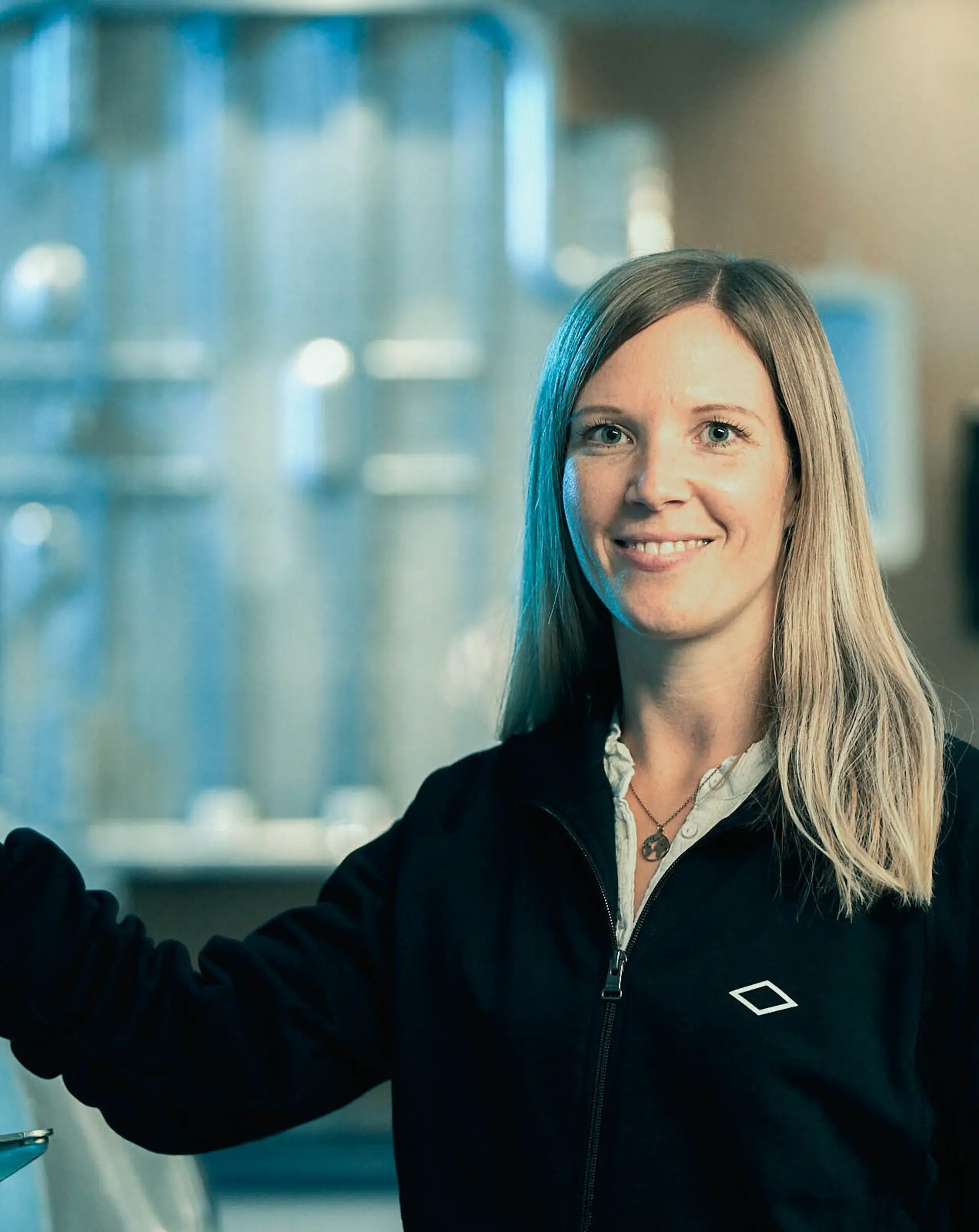 Smiling technician in a production lab