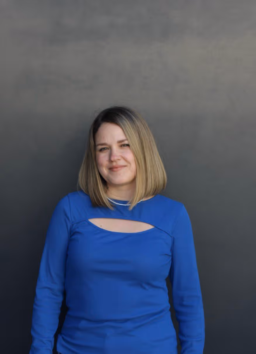 Die Frau auf dem Bild hat eine Bobfrisur und trägt ein leuchtend blaues Langarm Shirt. Natalia Davydova