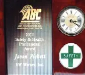 ABC safety award certificate and clock with green first aid cross