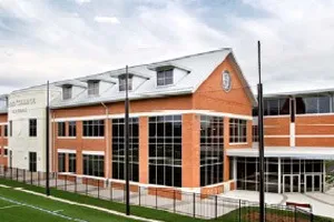 Modern brick and glass building with multiple windows and architectural details