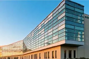 Modern glass and brick office building with blue sky backdrop