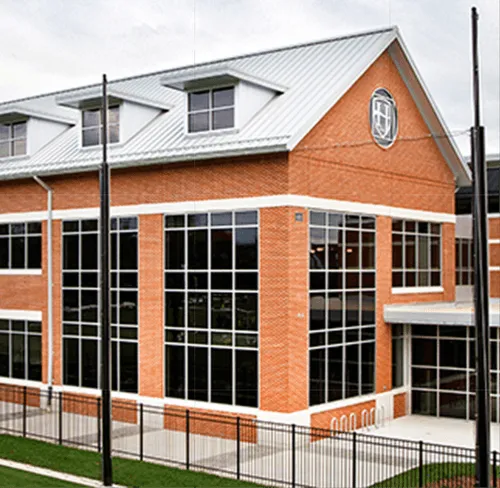 Modern brick and glass building with large windows and metal roof