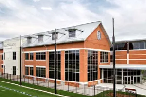 Modern brick and glass building with multiple levels and large windows