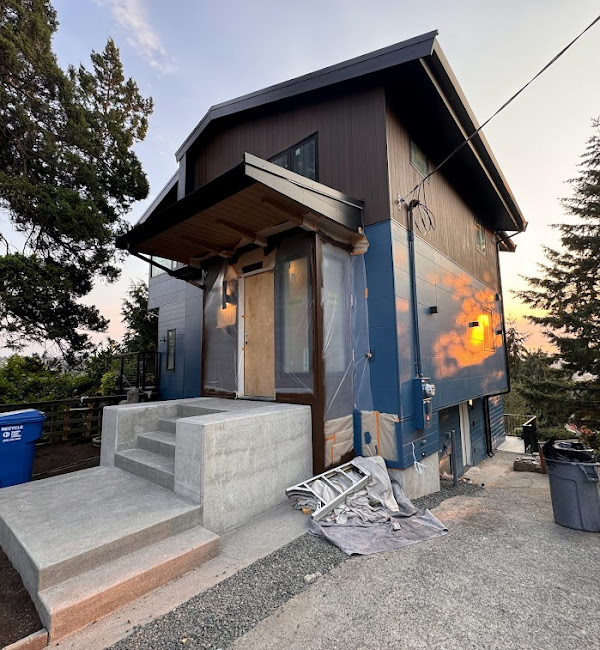 Exterior walls covered with a weather-resistant barrier in preparation for ventilated rainscreen and Nichiha siding installation.