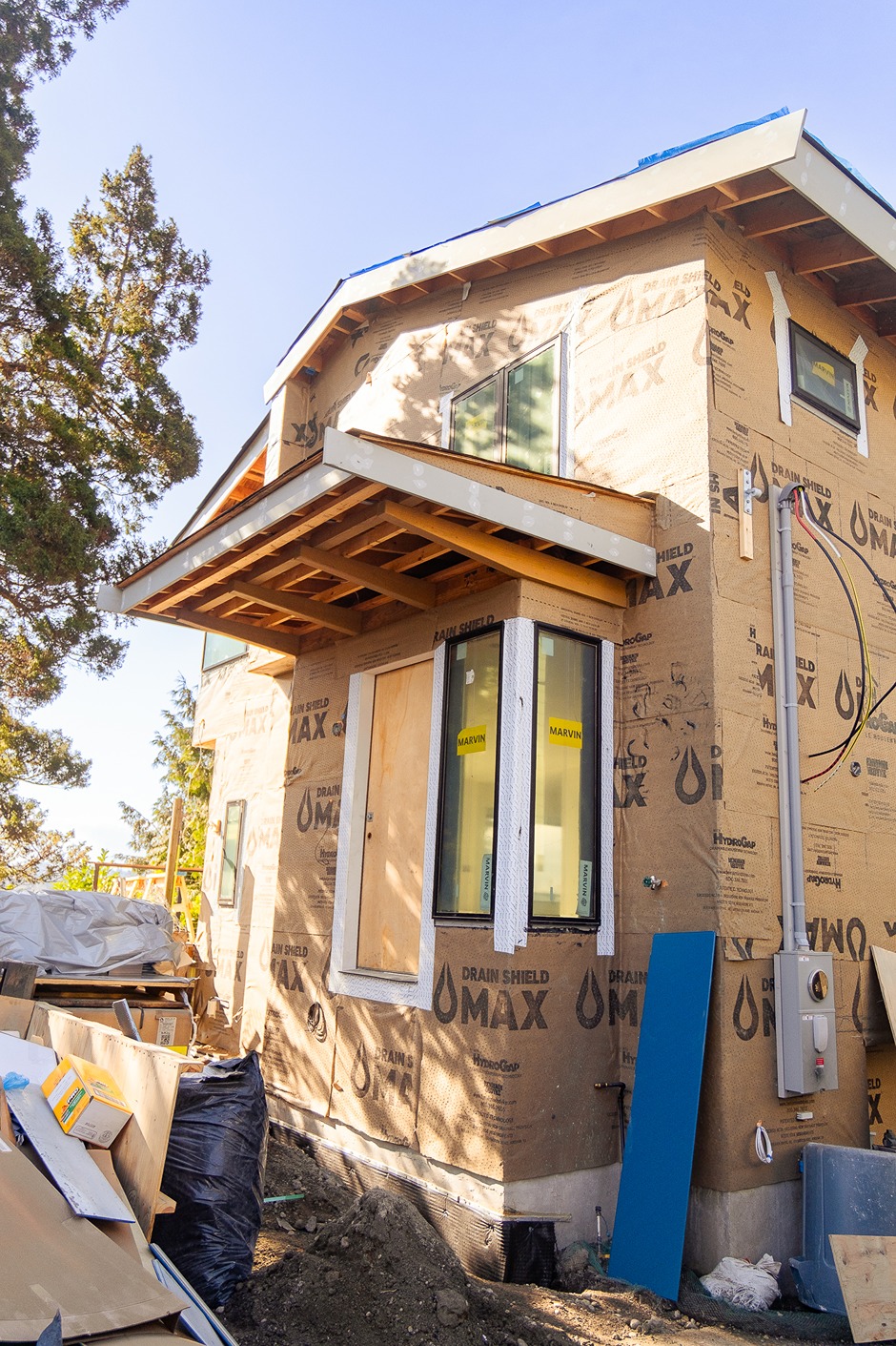 House exterior with vertical furring strips installed over the weather barrier, preparing for Nichiha siding attachment.