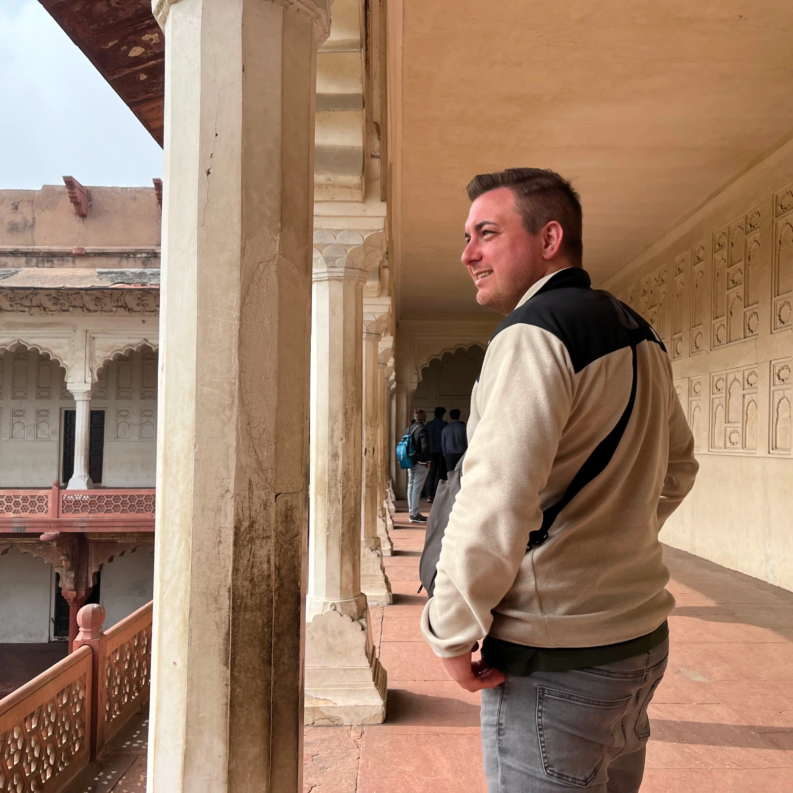 Portrait of Morten Stig Christensen smiling in an architectural setting, introducing the creative digital designer behind crafted digital identities, websites, and product experiences.