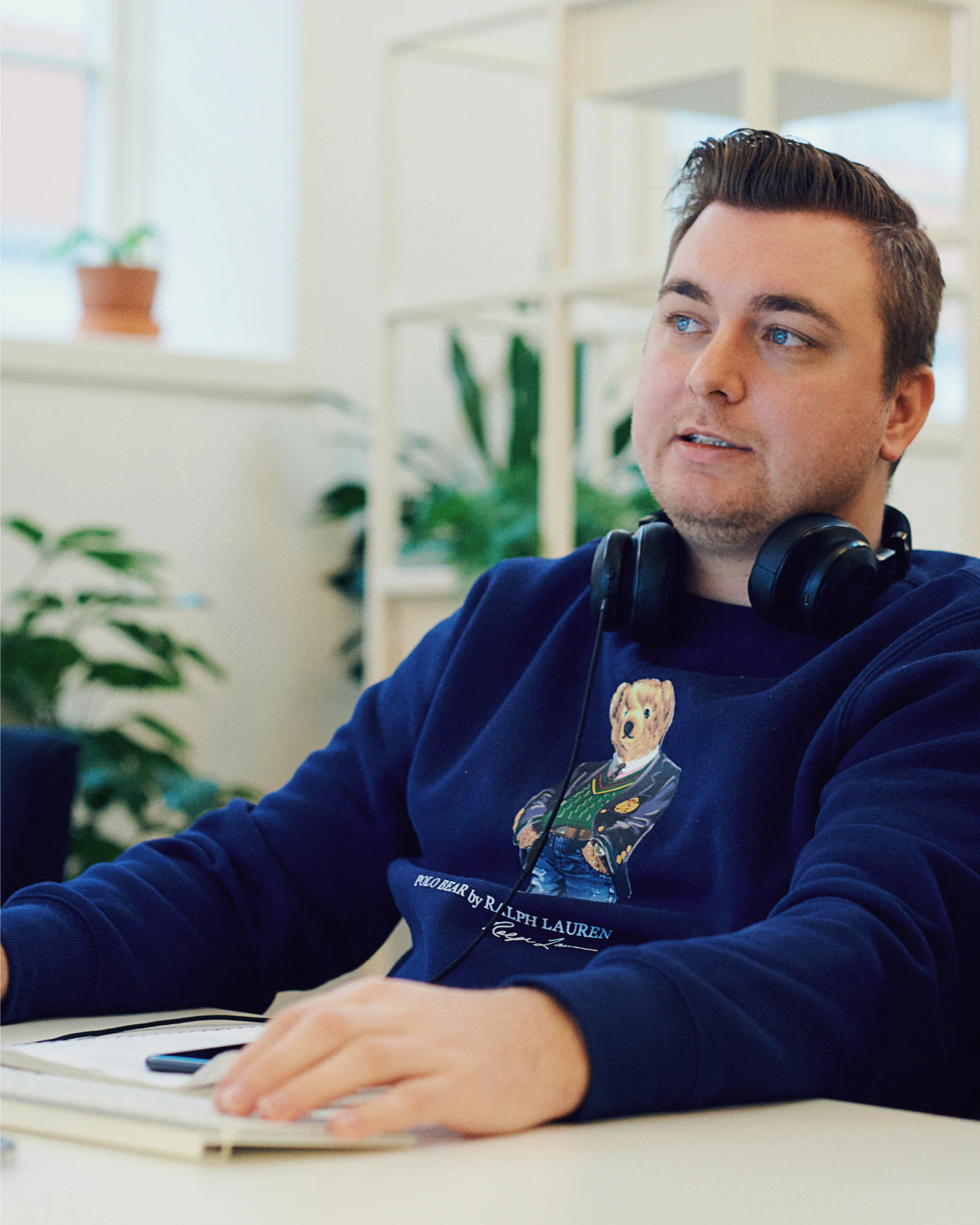 Morten Stig Christensen working in a plant-filled office environment, presenting the creative digital designer and developer in his workspace focused on craft, strategy, and digital experiences.