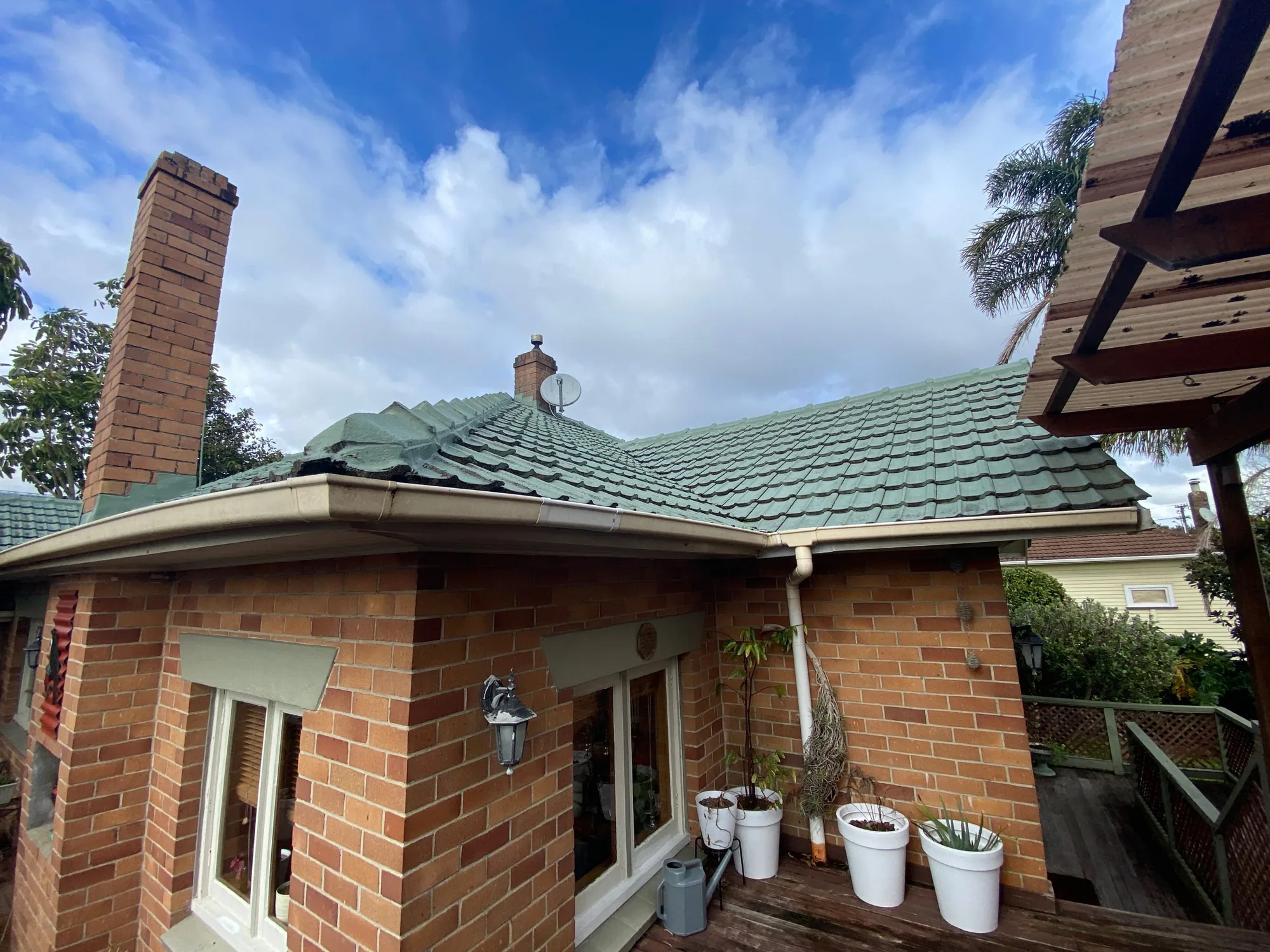 The Morningside home before the reroof, with its original concrete tile roof
