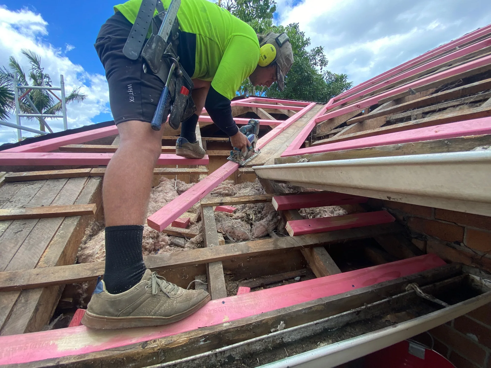 Impact Roofing team member cutting new purlins on the Morningside reroof