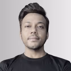 Portrait of a young man with short dark hair and a slight smile wearing a black shirt against a plain light background.