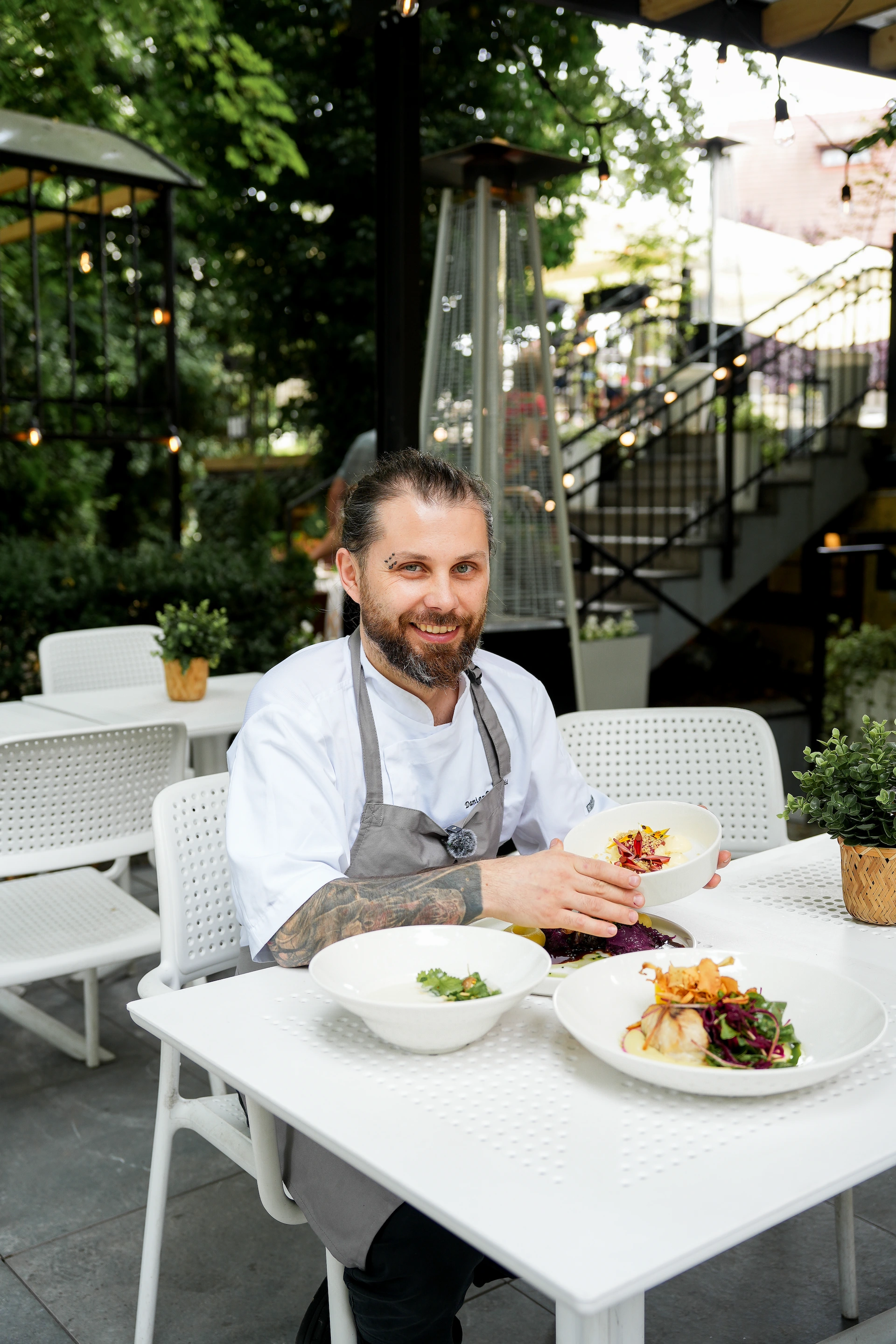 A cook sitting in a front of dining table