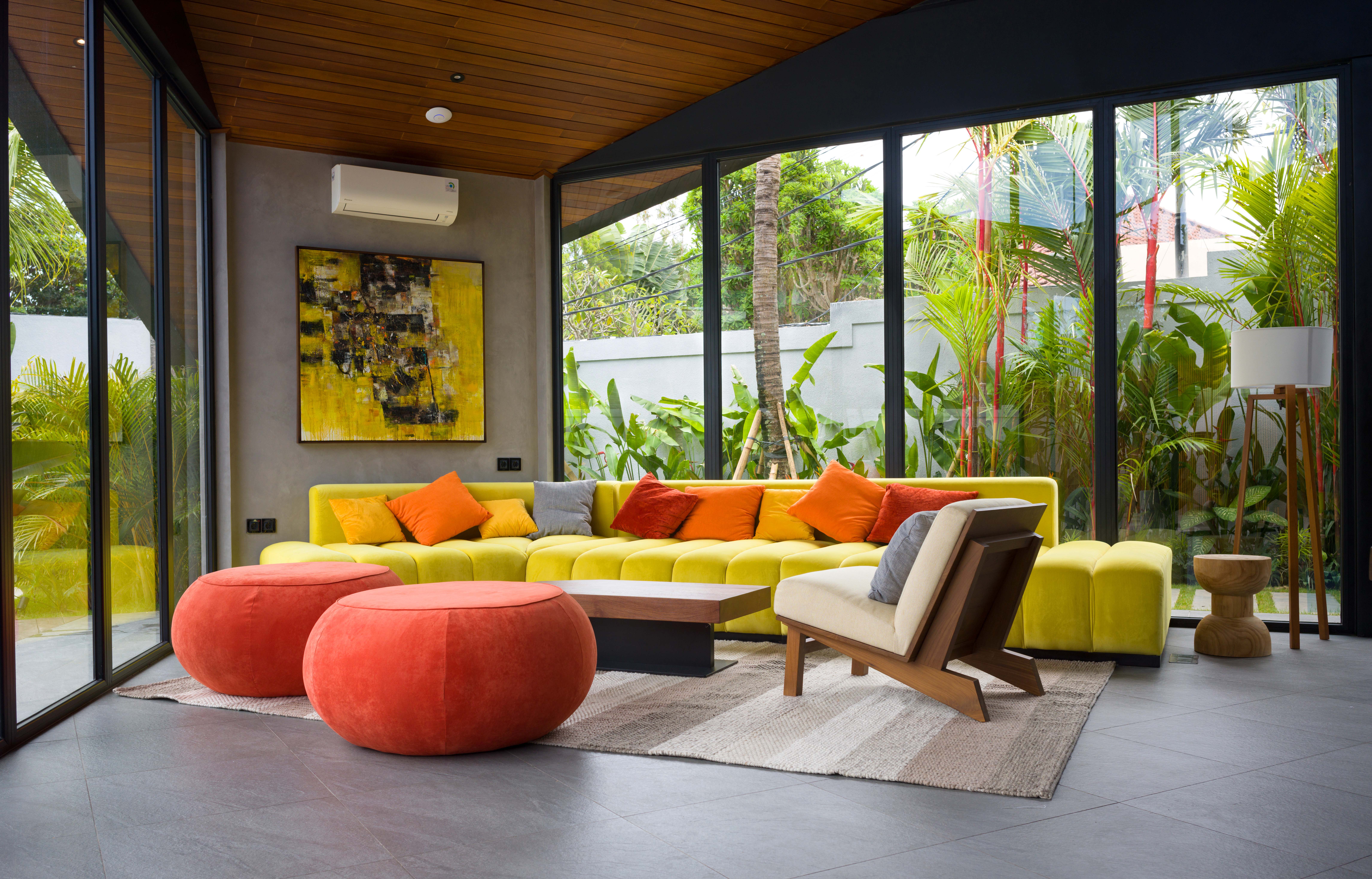 Panoramic glass walls in the living room dissolve the boundaries between interior and nature