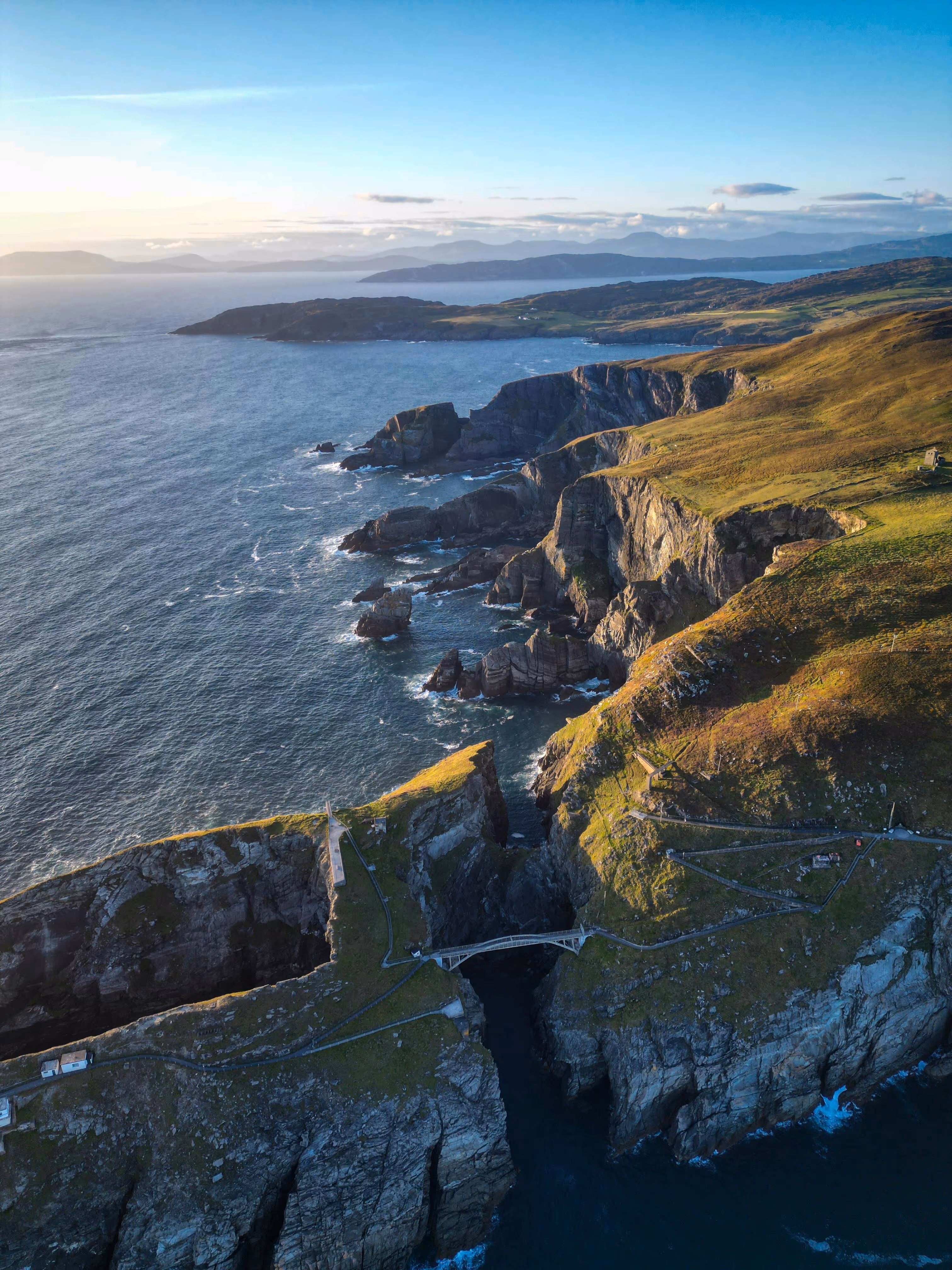 Aerial view of green sea cliffs and a rocky coastline