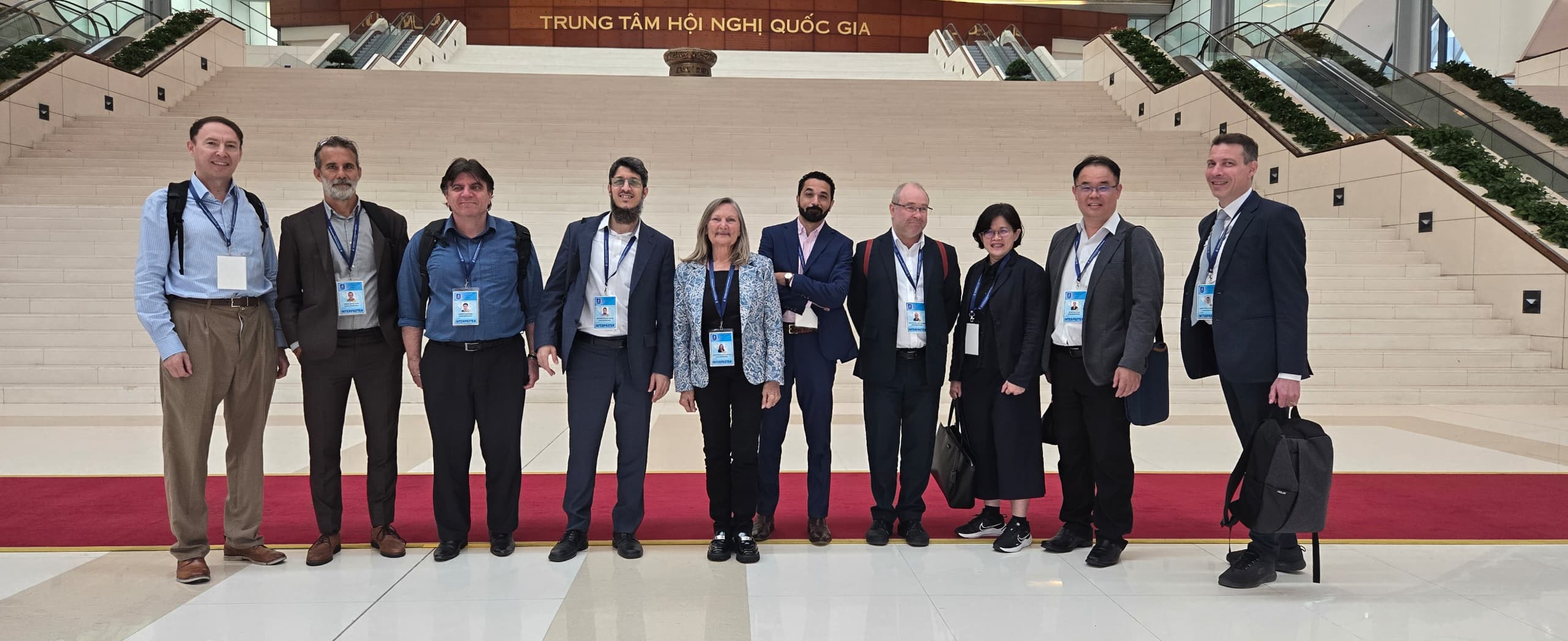 Interpretation team standing in front of the steps of a conference centre