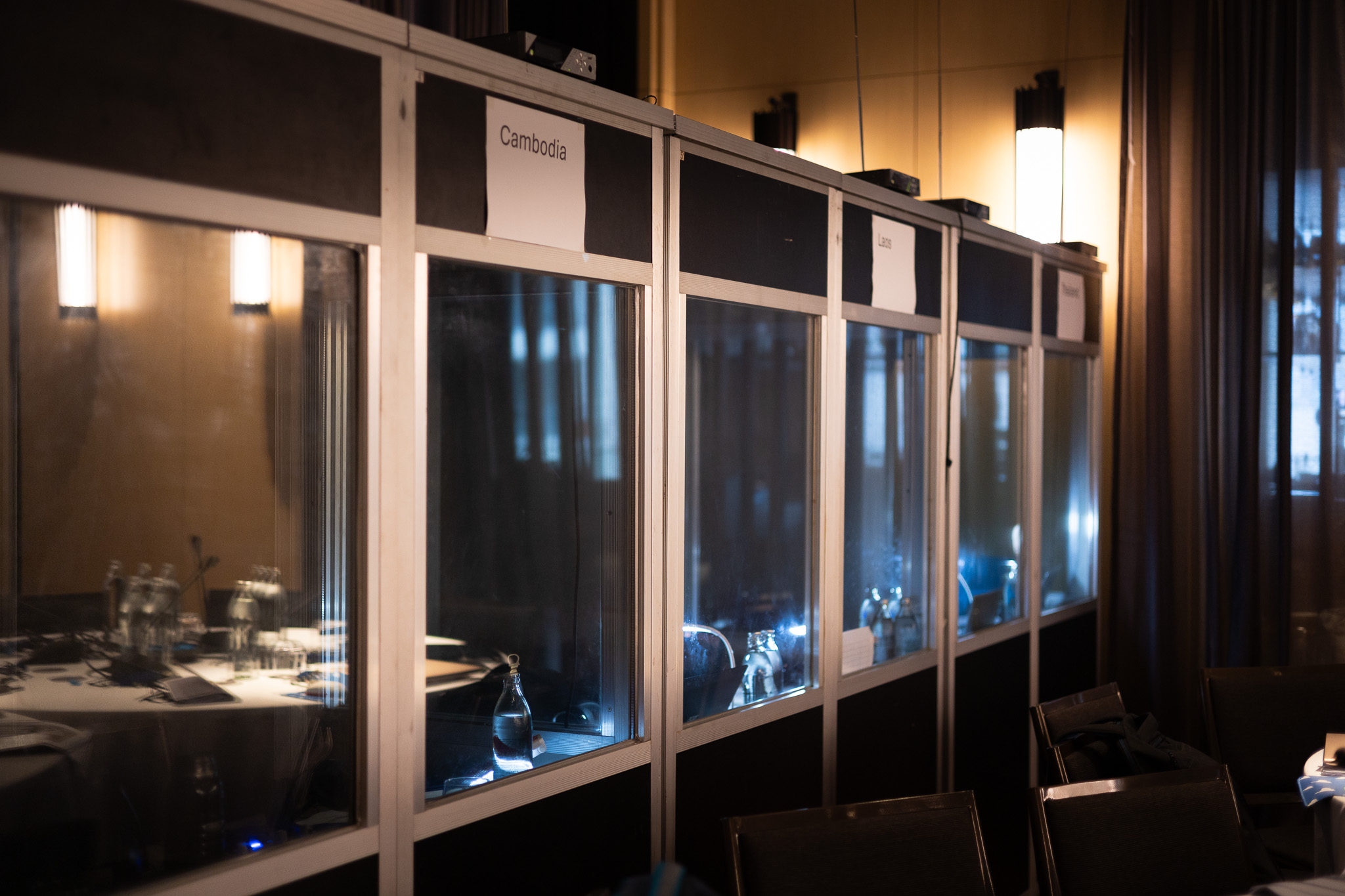 Row of interpreter booths along the wall of a conference room