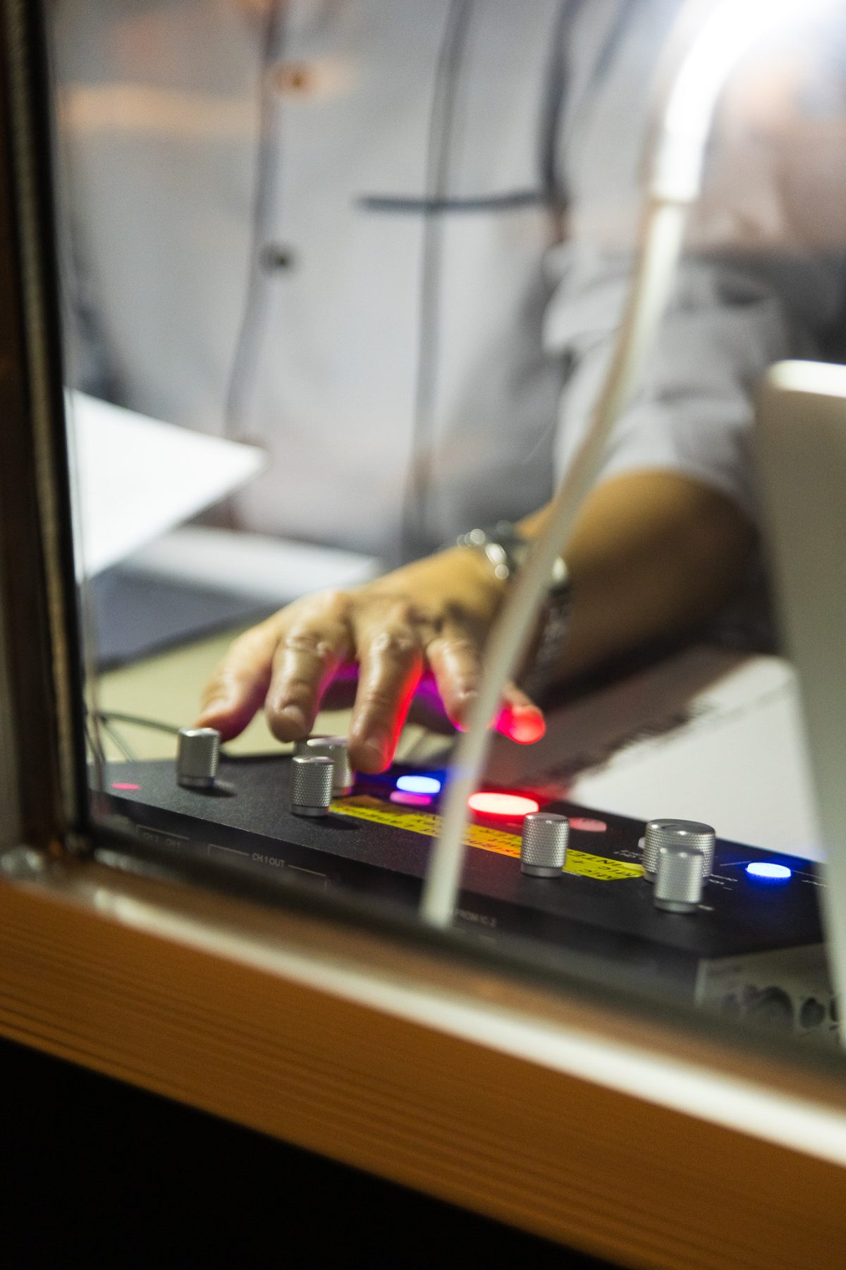 Interpreter adjusting a simultaneous interpretation console inside a booth