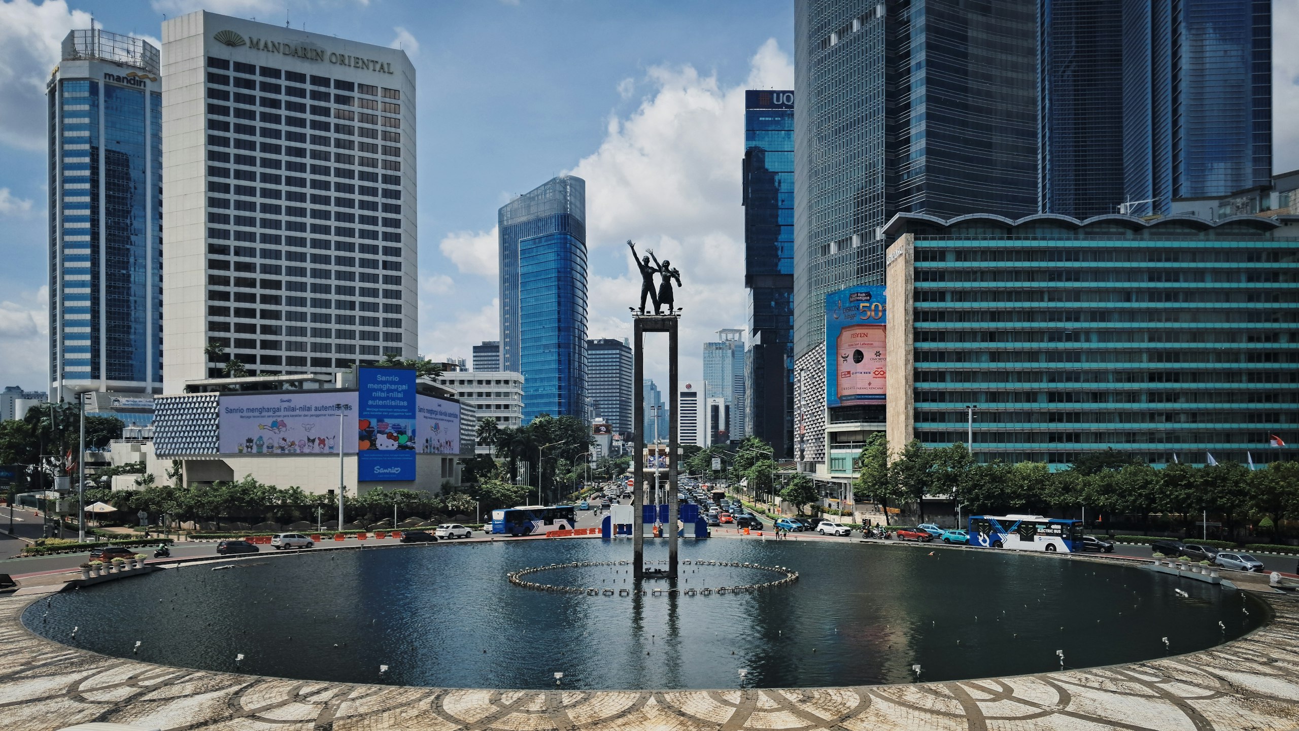 Selamat Datang Monument at Bundaran HI surrounded by office towers in central Jakarta