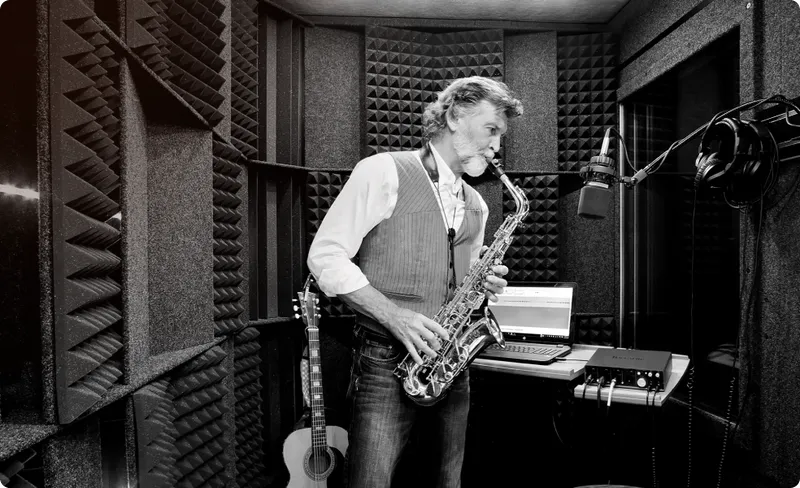 Saxophonist recording his practice session inside a WhisperRoom soundproof booth, illustrating the ability to practice freely.