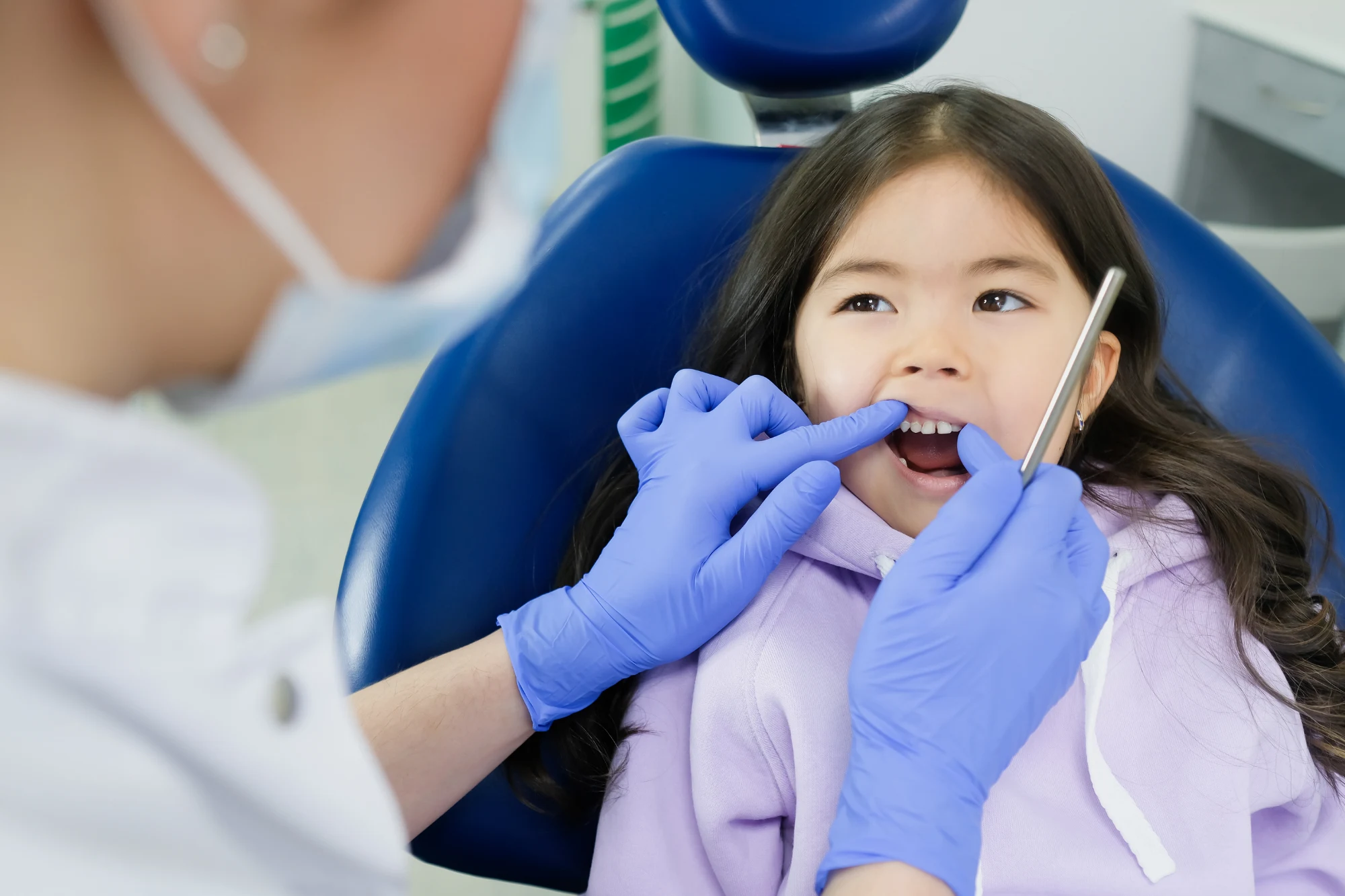 Pediatric dentist treating a young child