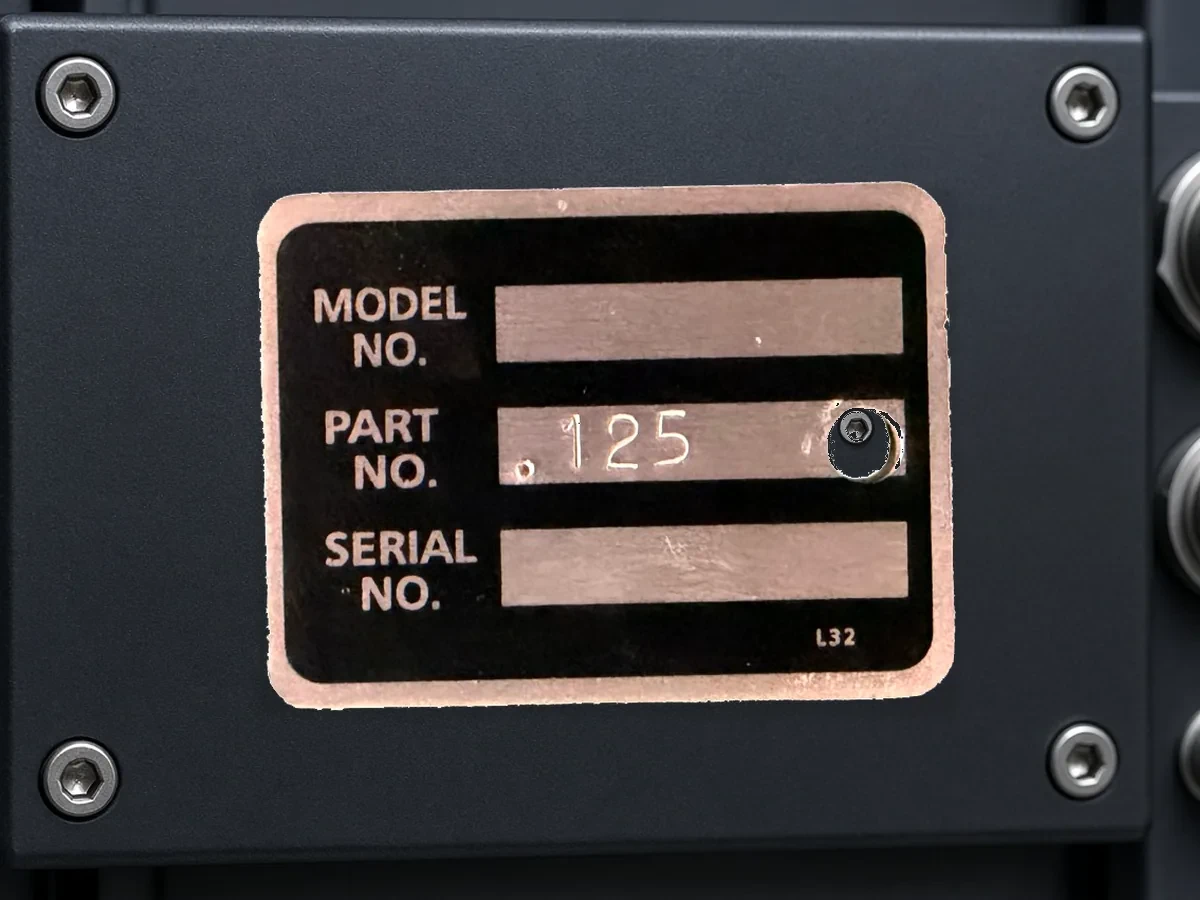 Photosensitive aluminum model and serial identification plate on aerospace ground-support equipment.