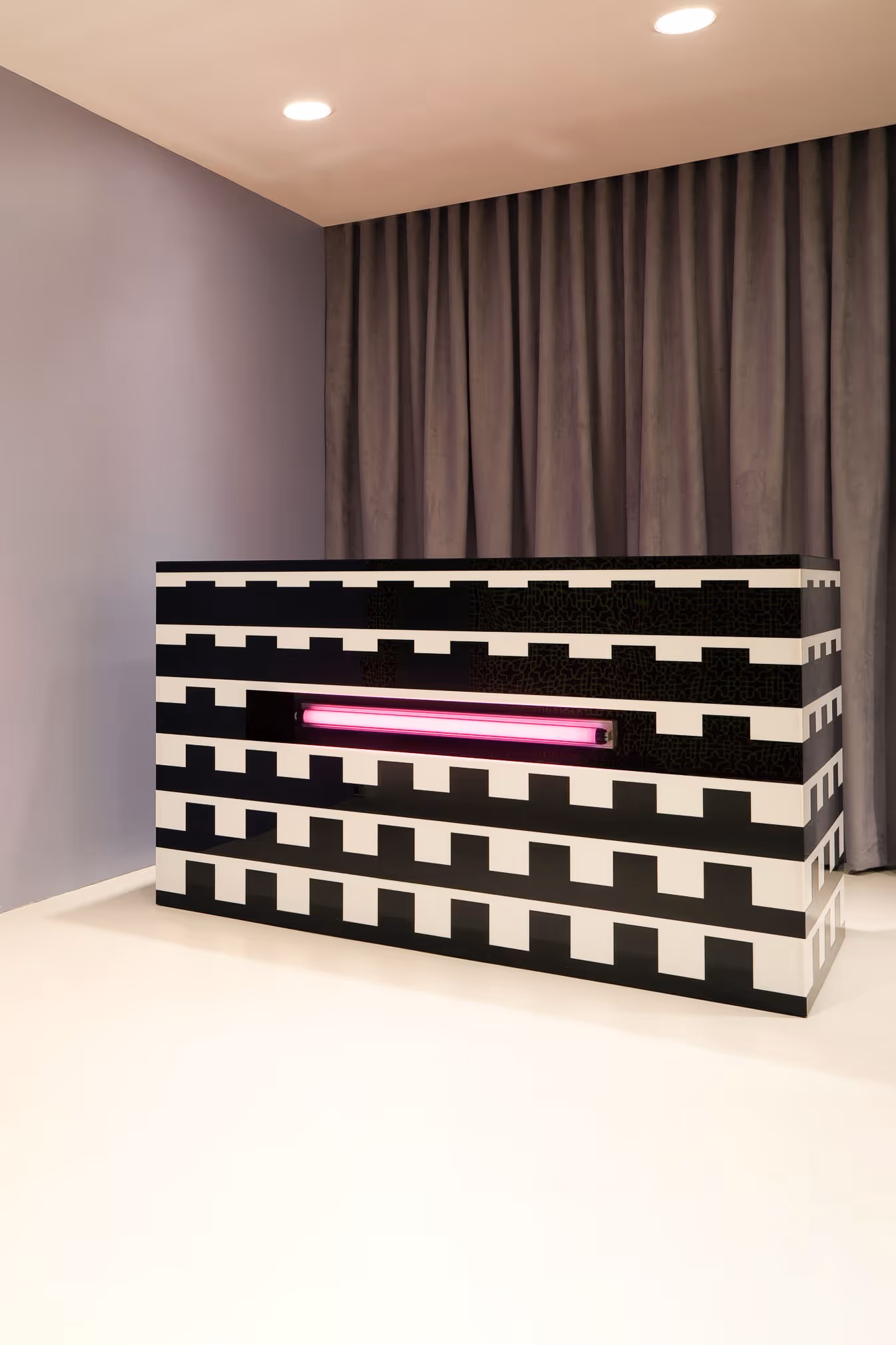Kensiegirl Fashion Showroom Design entry desk in bold black and white plexiglass with pink neon. Memphis / Alchimia Design inspired
