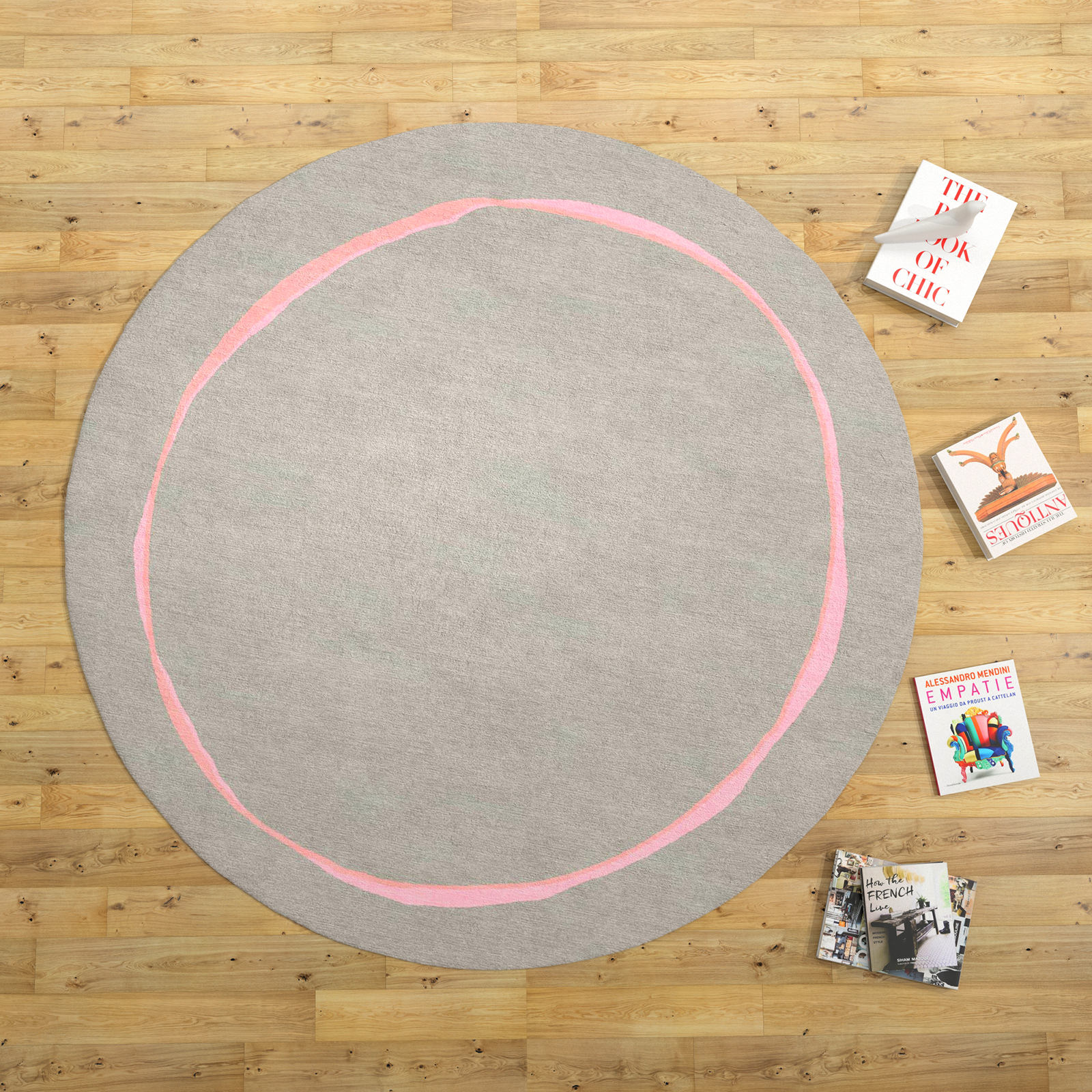 Round gray rug with a single imperfect pink circular line across the center in room settings