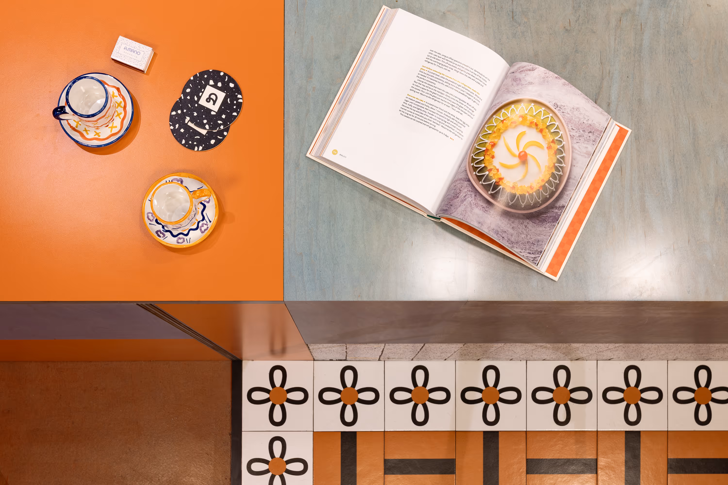 Coffee Shop Design New York - Detail of the cafe counter with an open recipe book and a coffee cup
