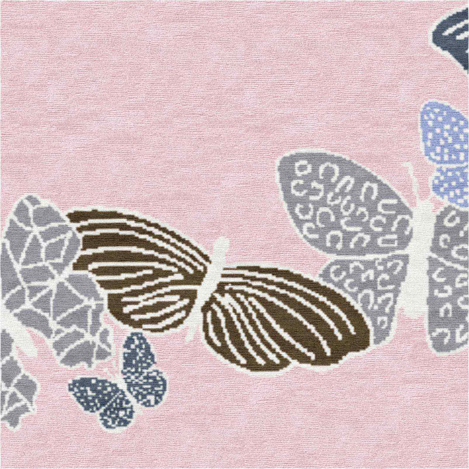 Detail of rose rug with butterfly wing patterns in earth and sky tones, luxurious wool and silk texture