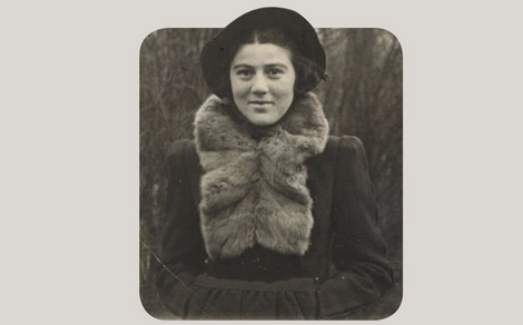 Archival portrait of a young woman in a dark coat and fur scarf, framed with rounded corners.
