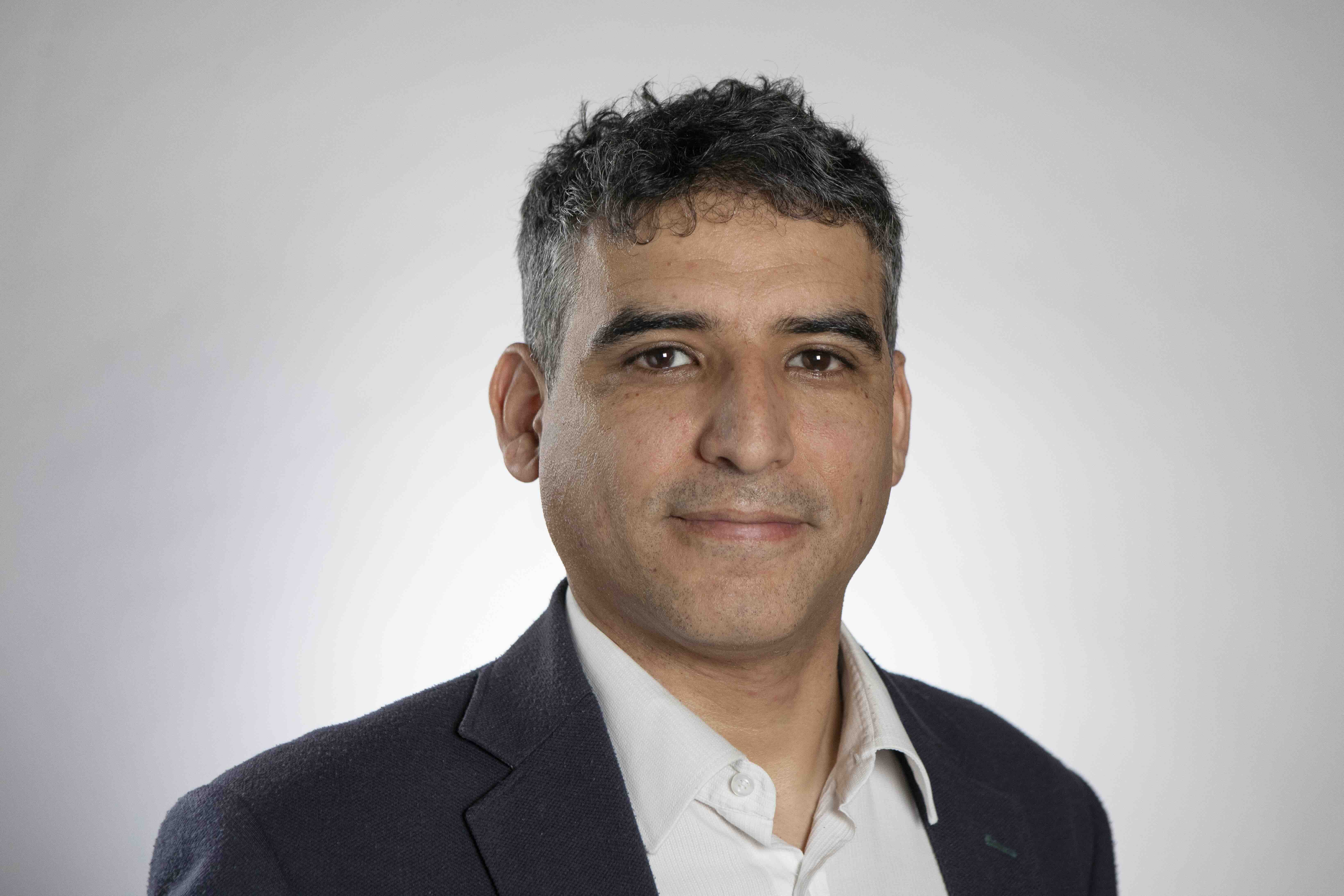 Headshot of Gustavo with white background.