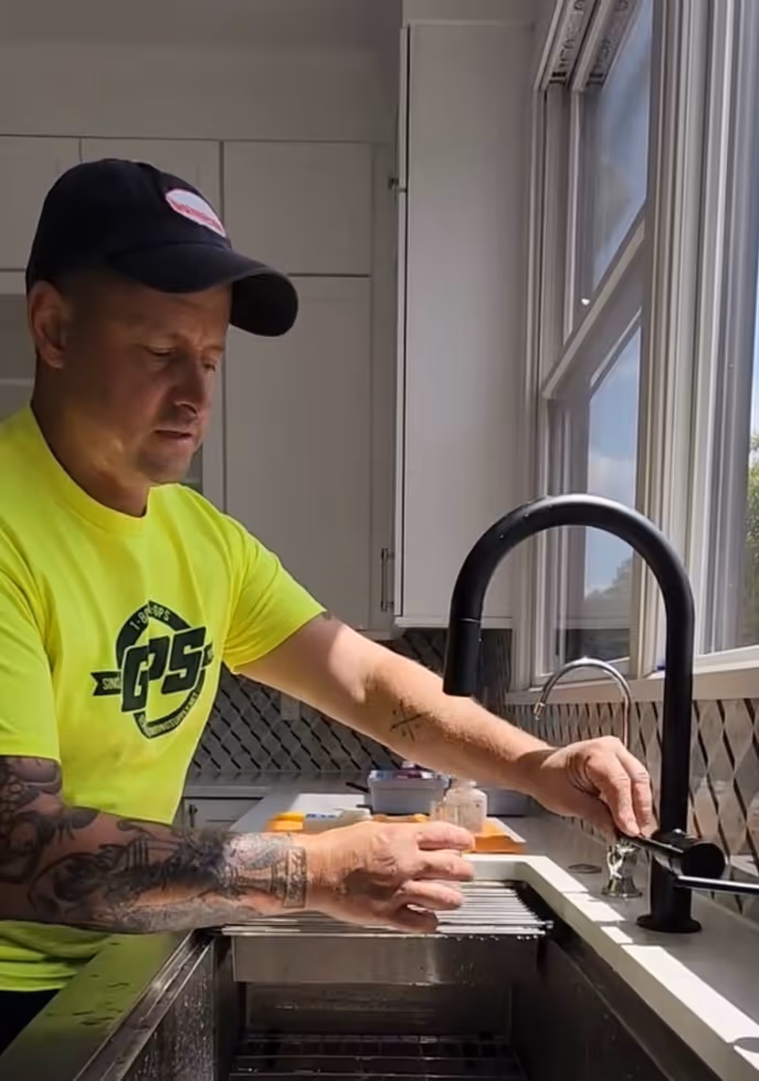 Flavio testing the water quality for a customer in their home as part of the free water test.