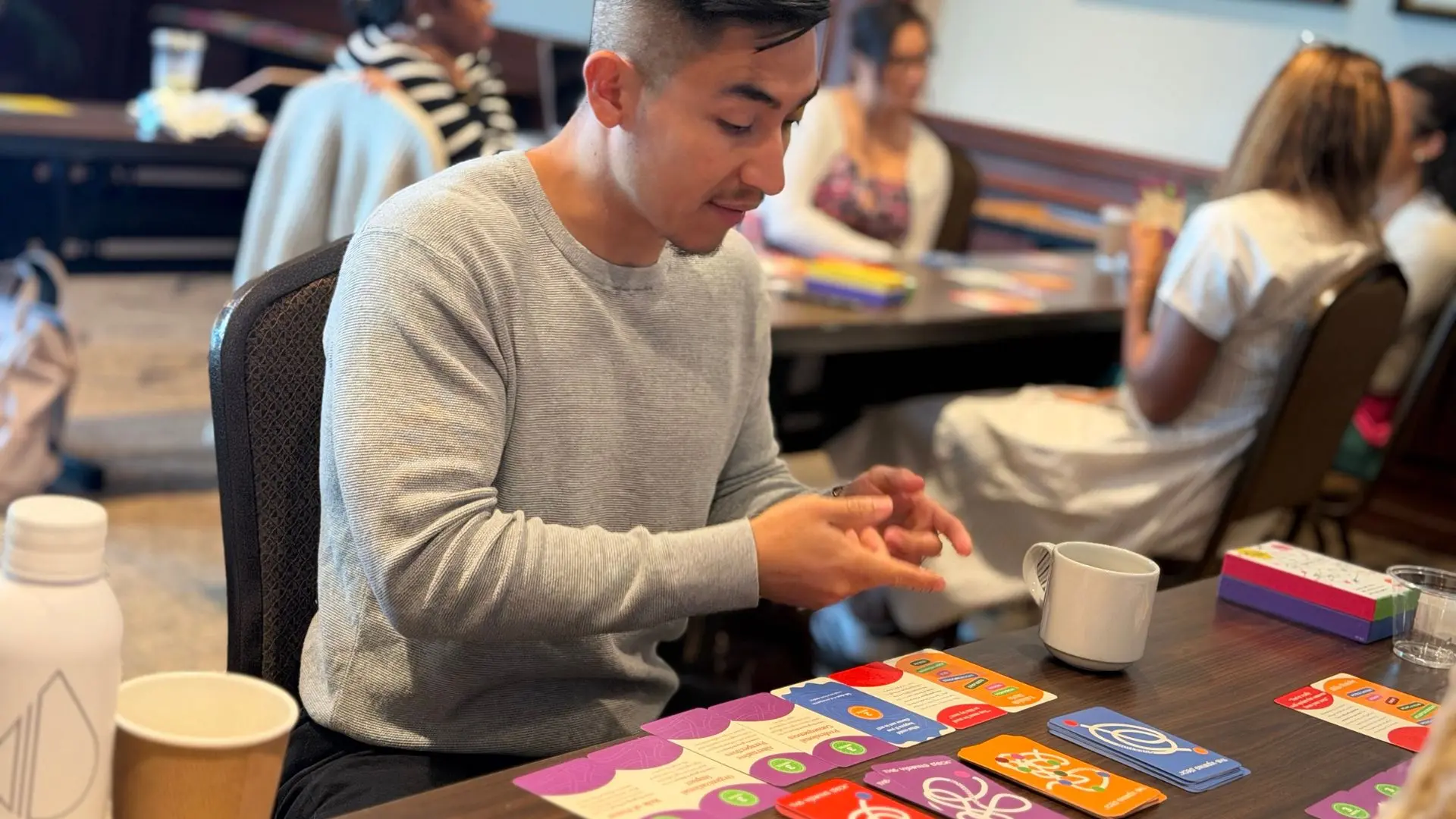 Young man viewing his cards.