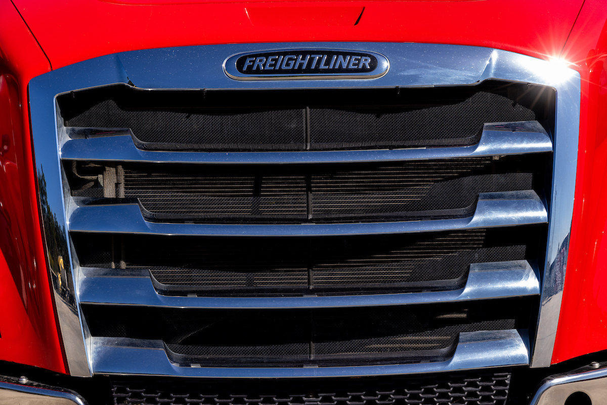The grill of a red Pinch Freightliner truck