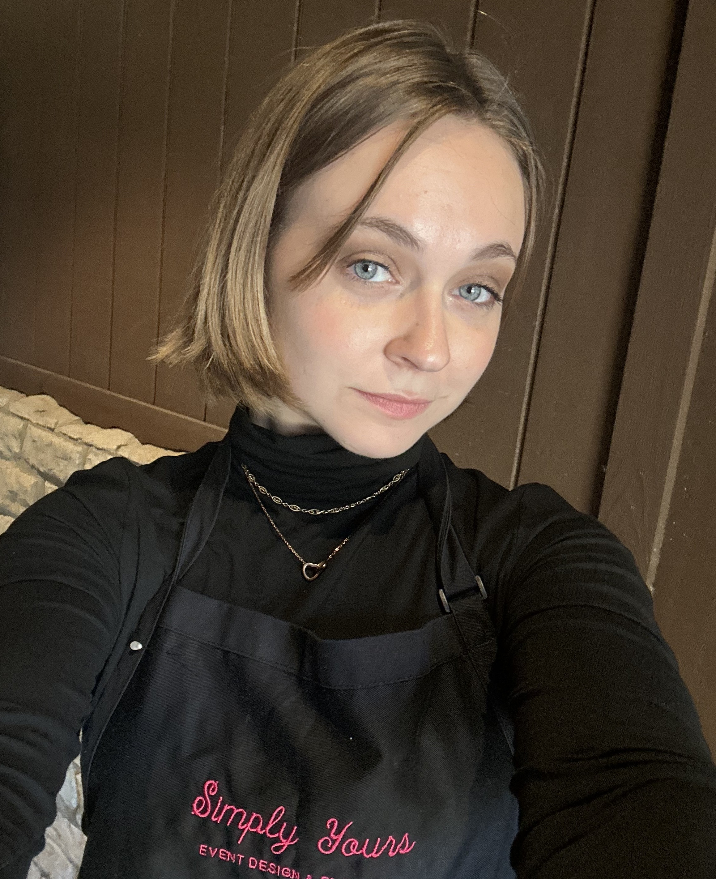 Person wearing all black and smirking.