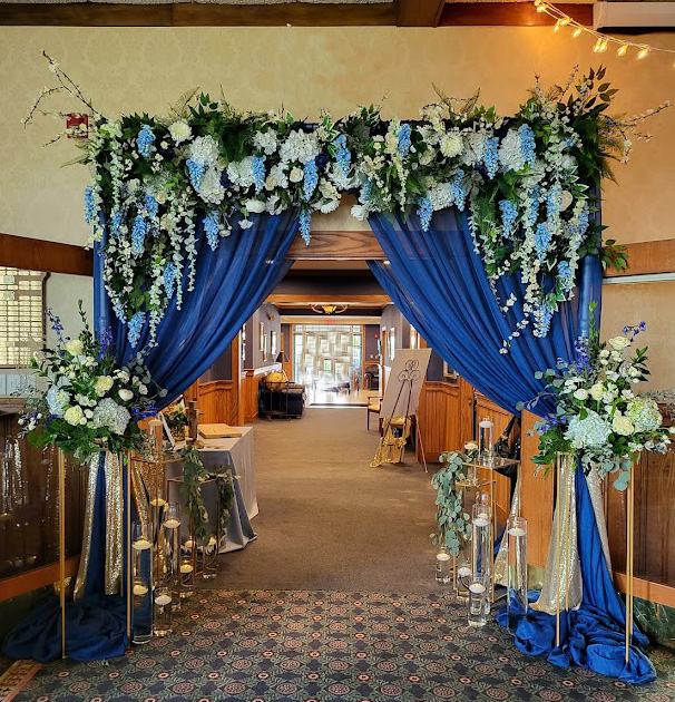 Door draping in royal blue with flower decoration all around. 