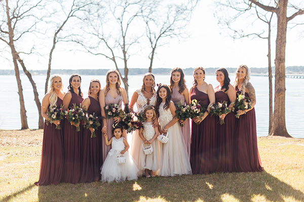 Women of the bridal party at the beach wearing burgundy.