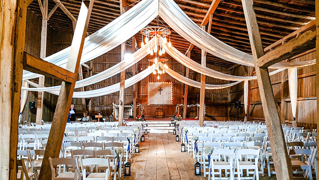 Linear barn draping on ceiling for ceremony. 