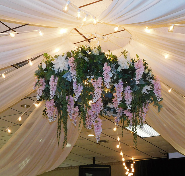 Ceiling wreath with pink and white flowers. 