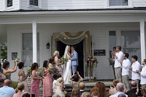 Celebrating a couple at the alter with the bridal party supporting them. 