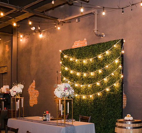 Green Box-wall with bistro lighting and head table design.