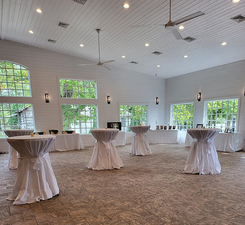 White cocktail tables set up for a cocktail hour at Gideon Owen. 