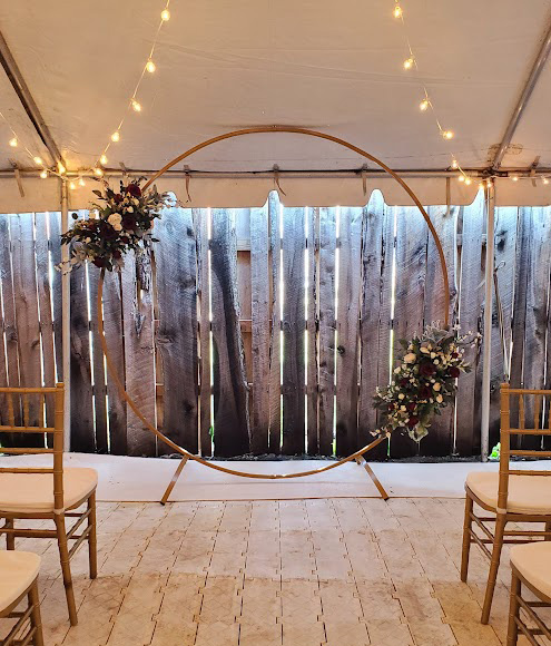 Circular arch with two floral decorations.