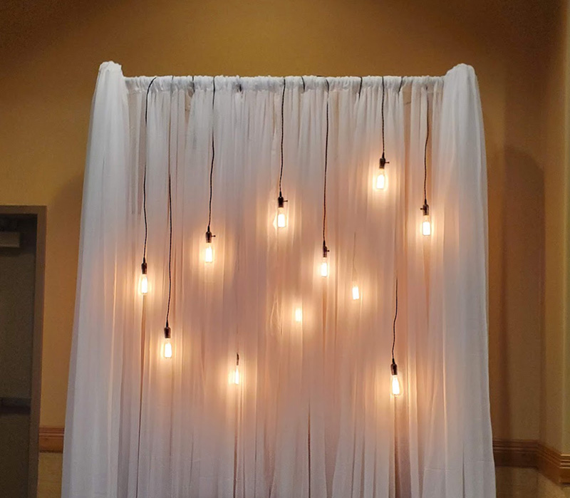 White Backdrop with Edison light decoration. 