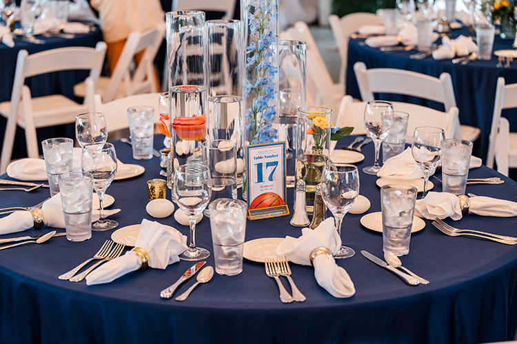 Table 17 with white napkins, silver flatware, and water glasses at each seat. 