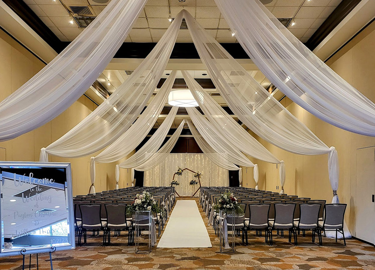Ceiling draping with arch and backdrop.